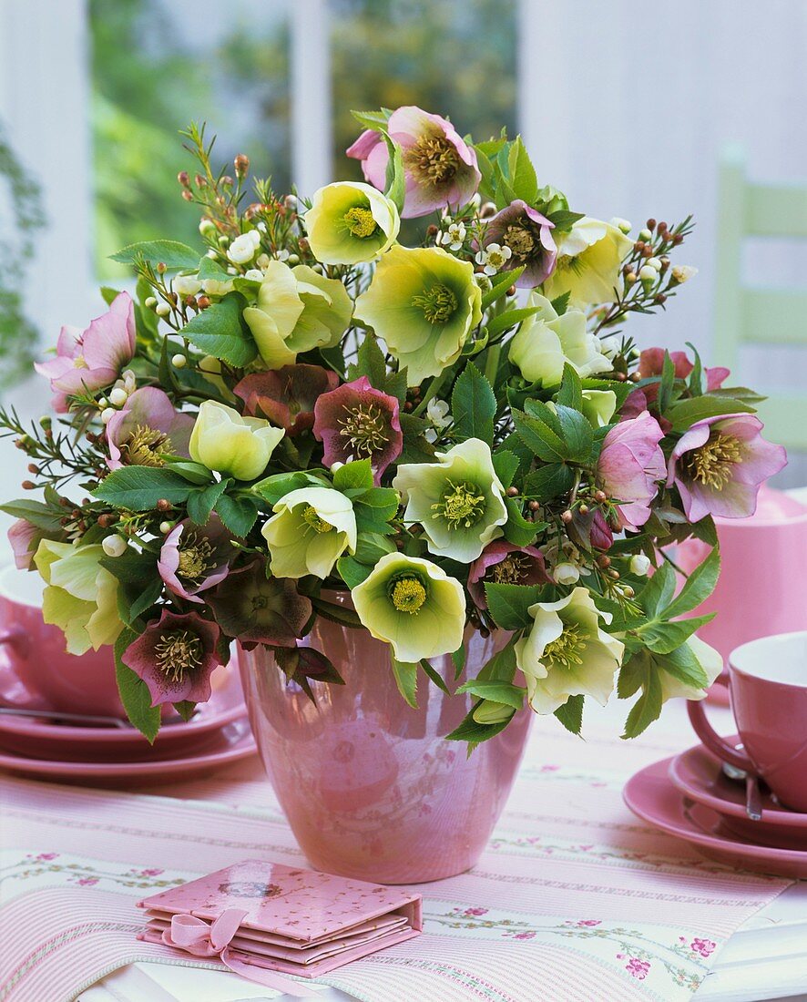 Vase of Christmas and Lenten roses and wax flowers
