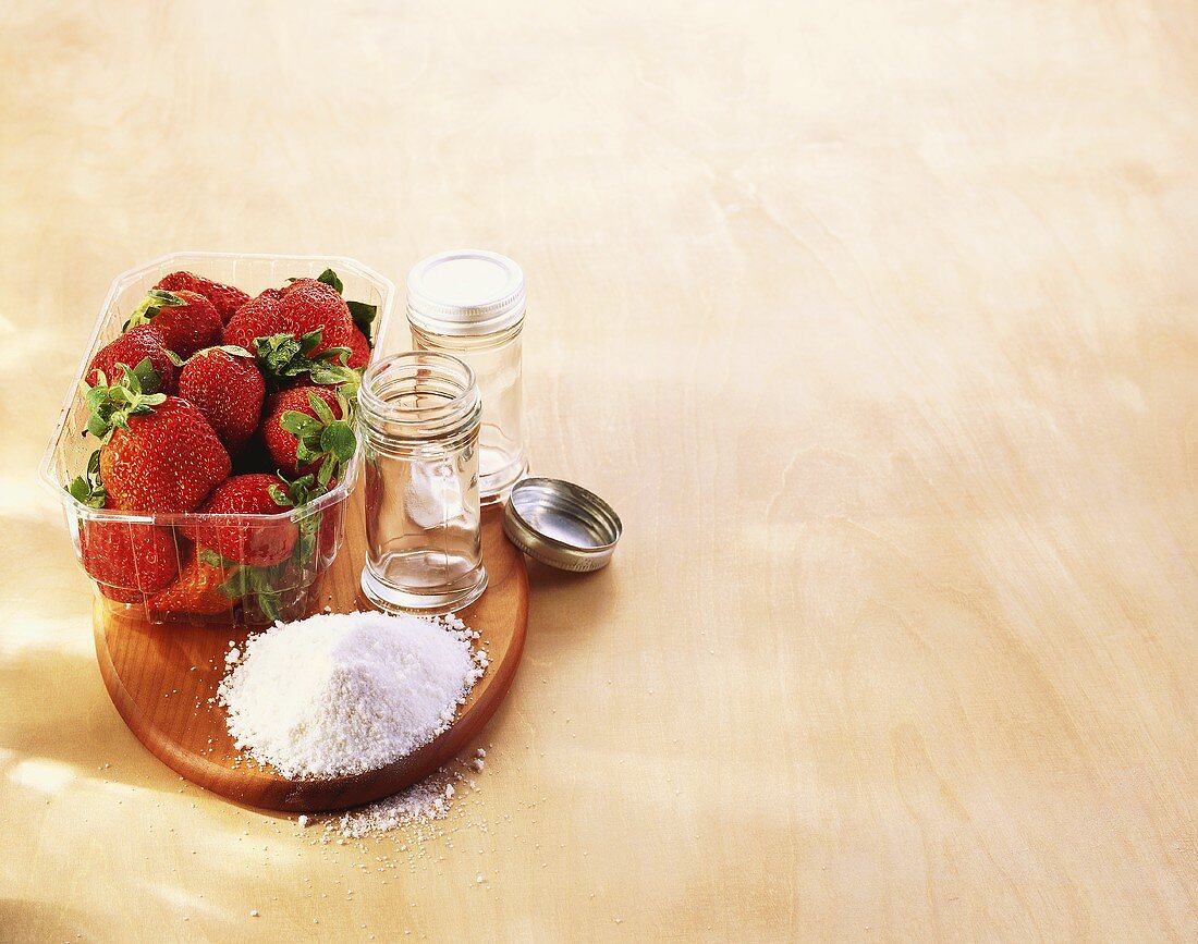 Strawberries, preserving sugar and preserving jars