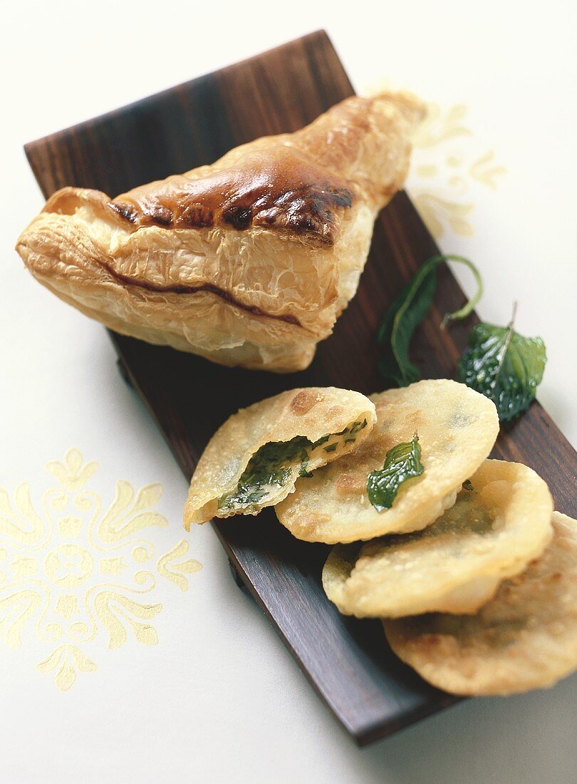 Spinach pie with puff pastry and noodle cakes with herbs