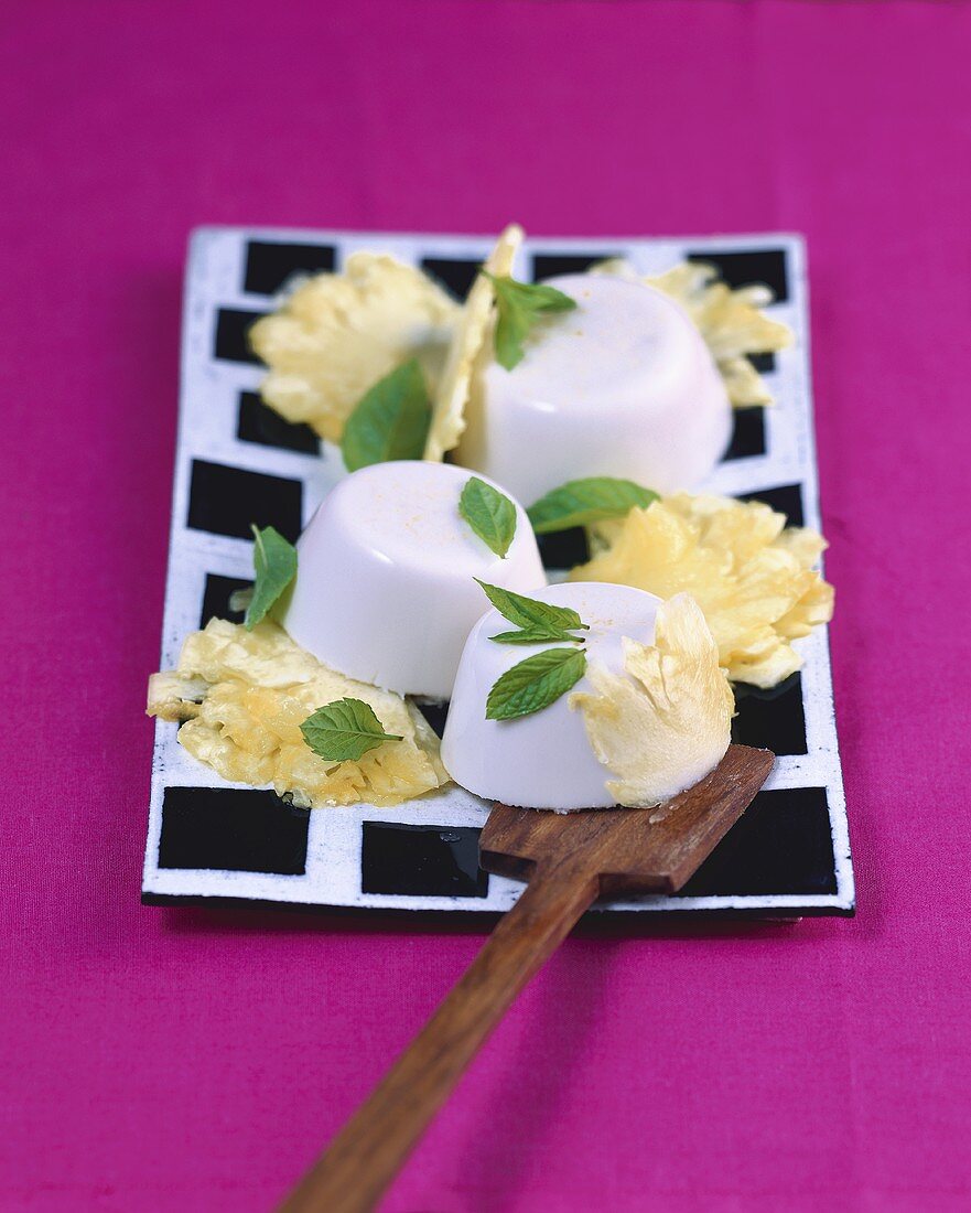 Coconut pudding with pineapple and mint
