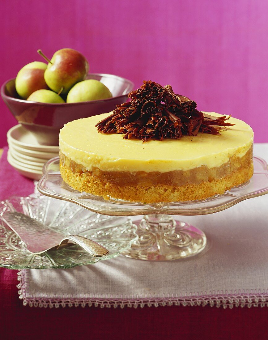 Advocaat cake with apple and chocolate curls on cake stand