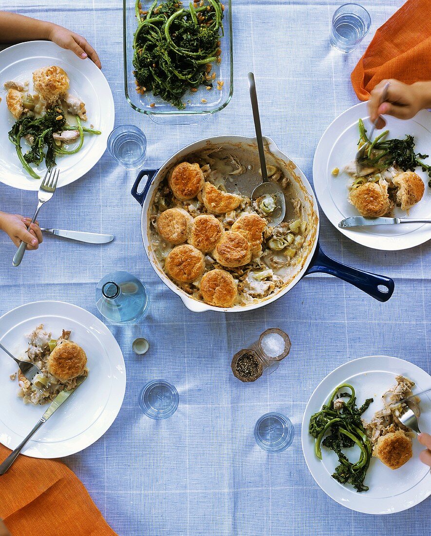 Chicken and leek cobbler and broccoli on laid table