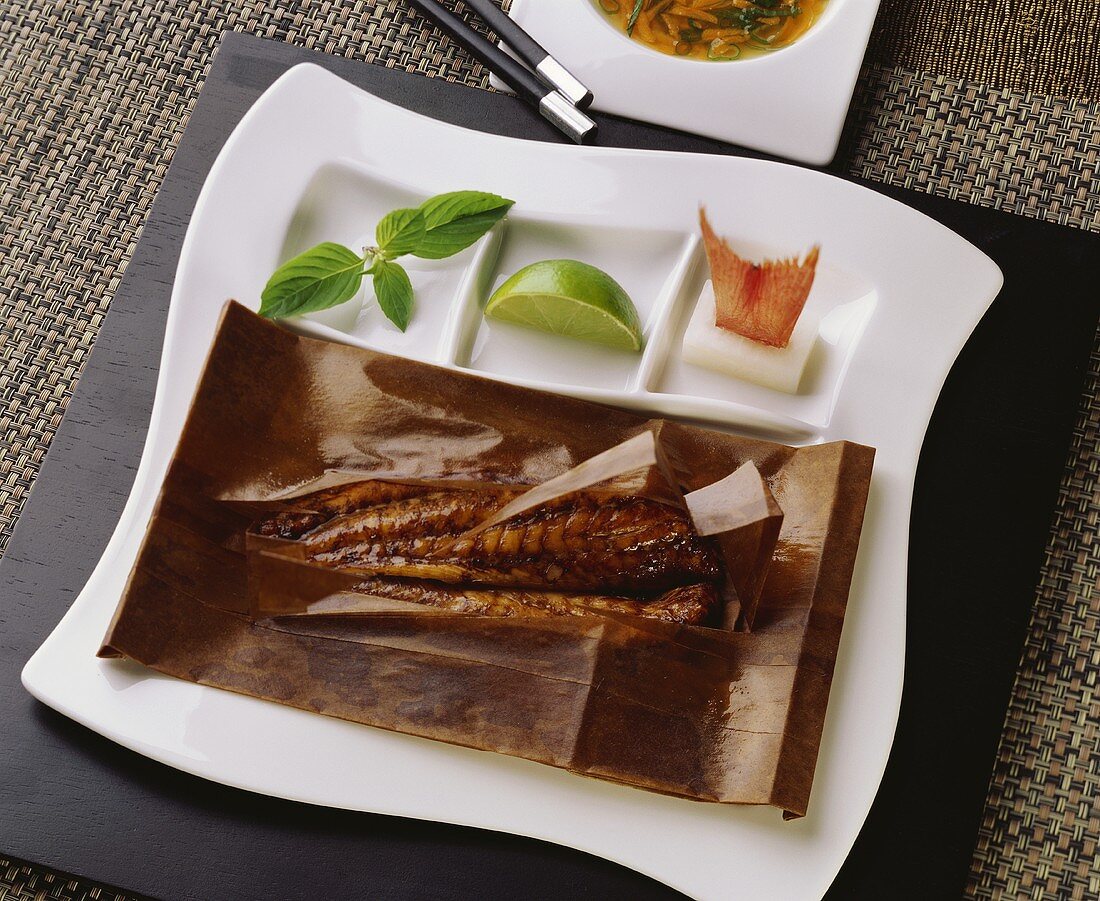 Fish in parchment paper and nam-manao sauce with herbs