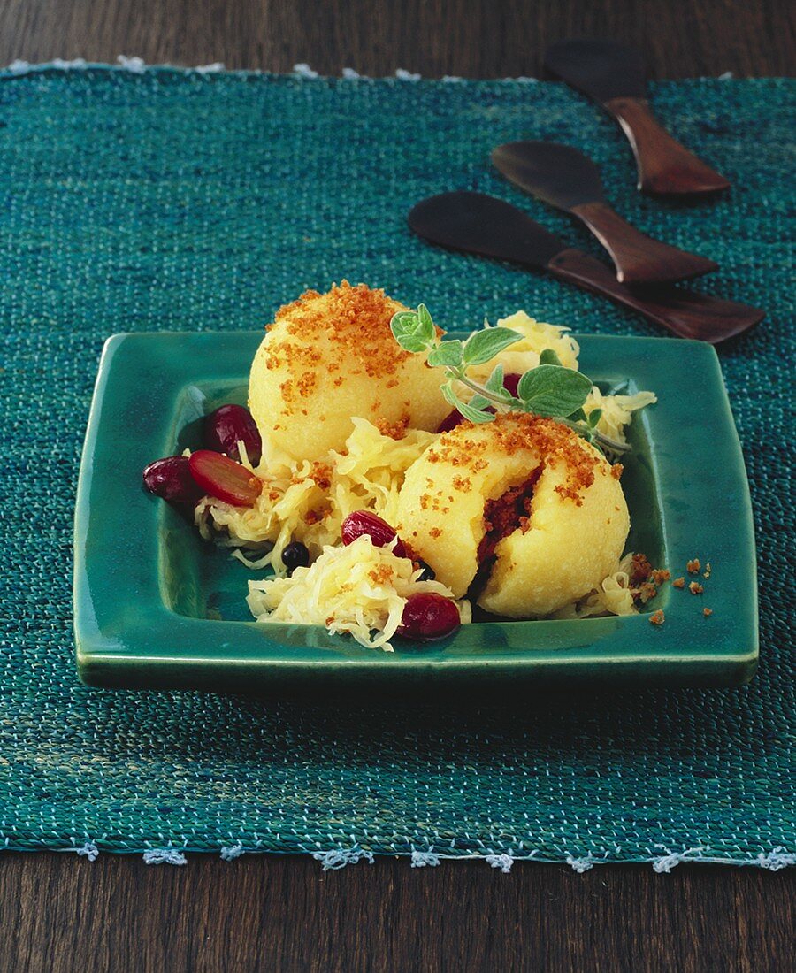 Potato dumplings filled with liver sausage on sauerkraut