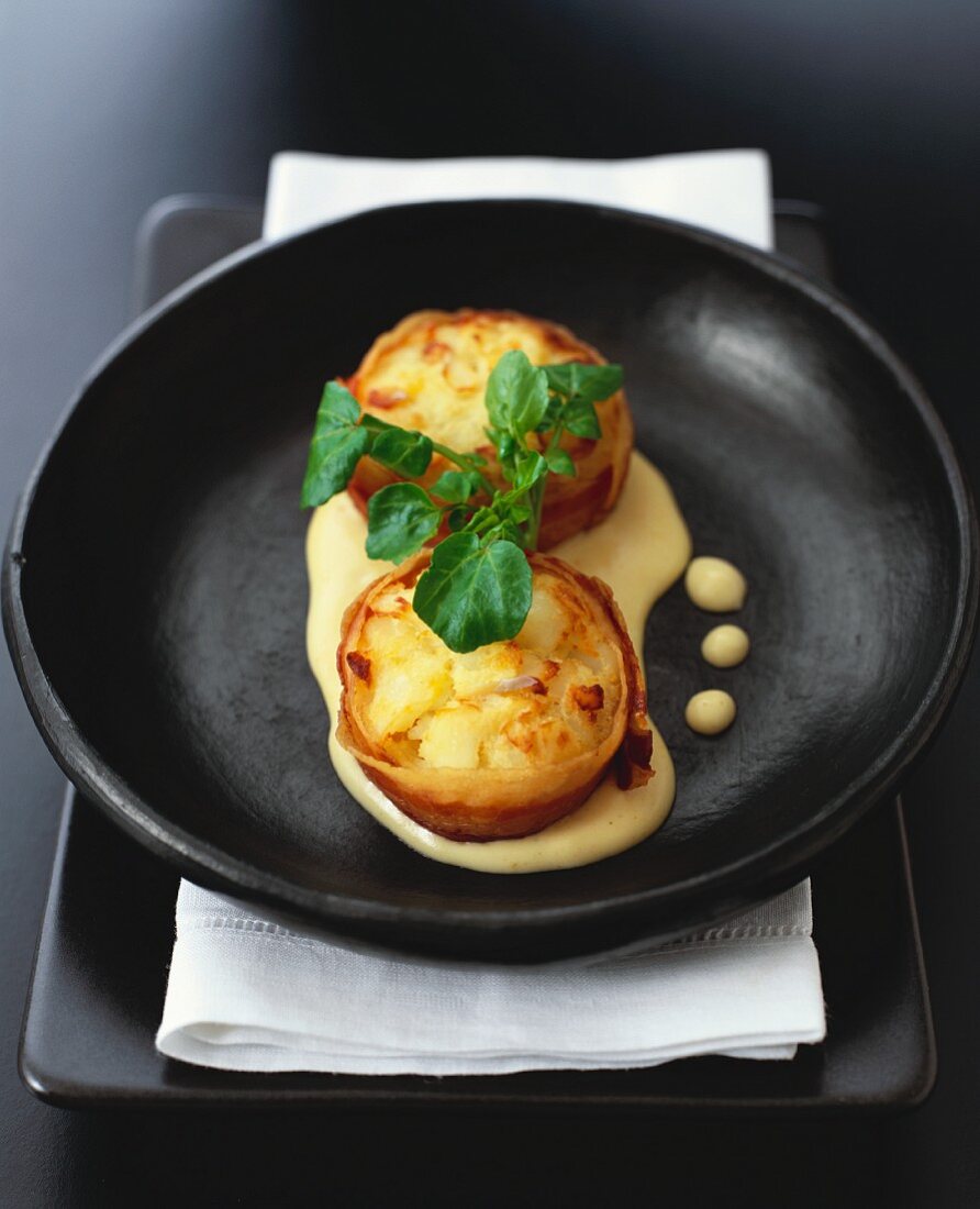 Oven-baked bacon-wrapped fish cakes with curry sauce