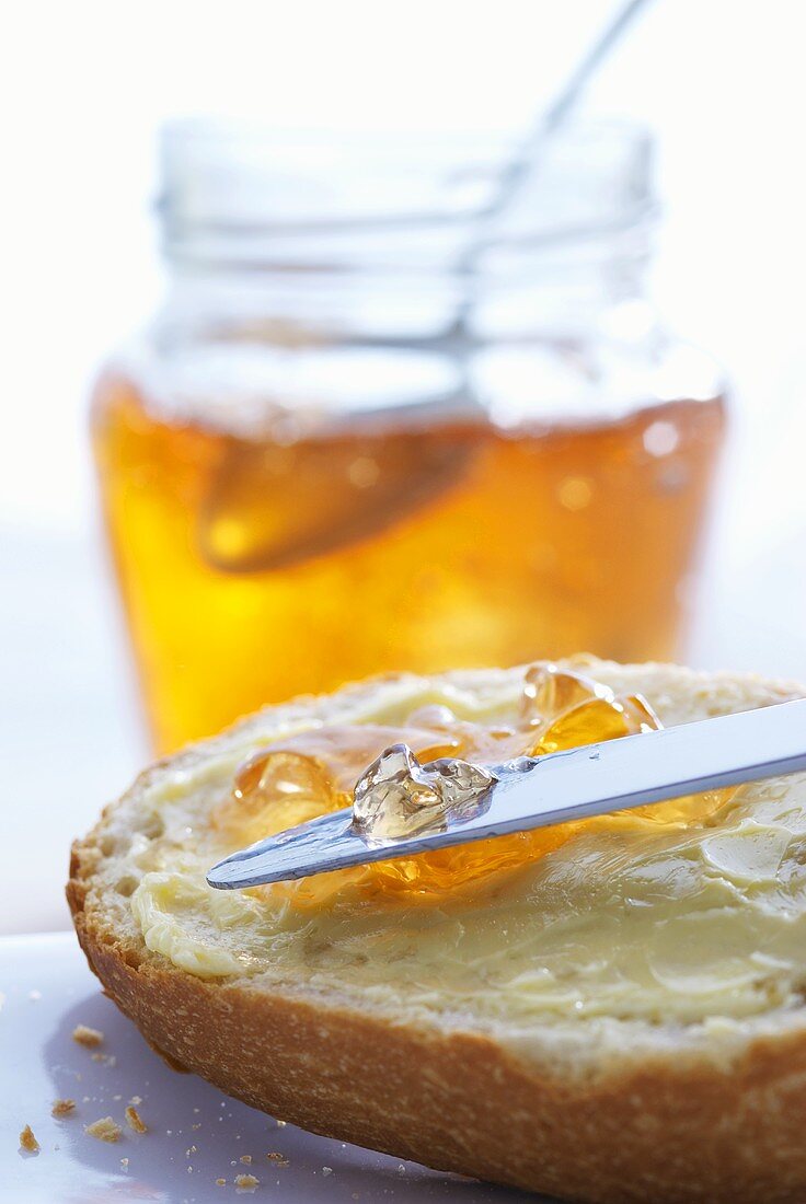 Spreading quince jelly on bread and butter
