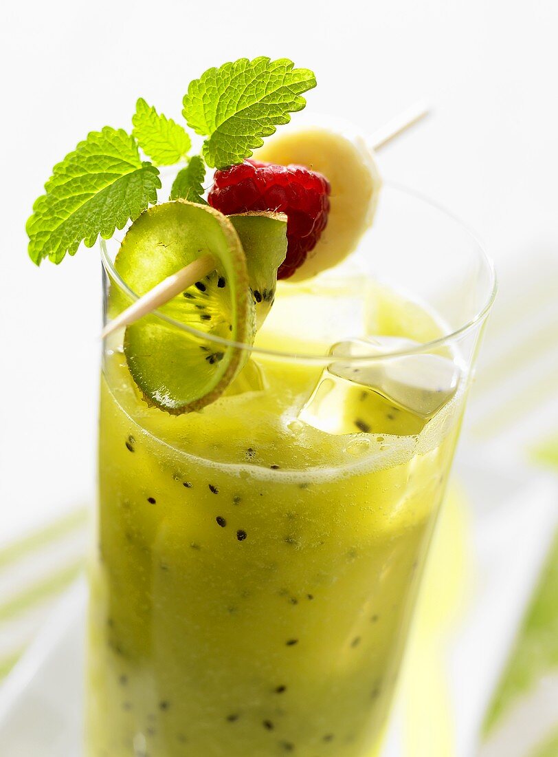 Kiwi fruit and banana drink with fruit on cocktail stick