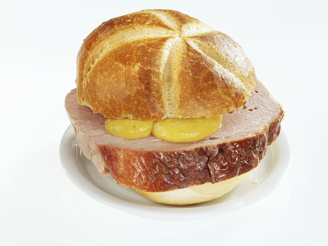 Slice of Leberkäse with mustard in bread roll