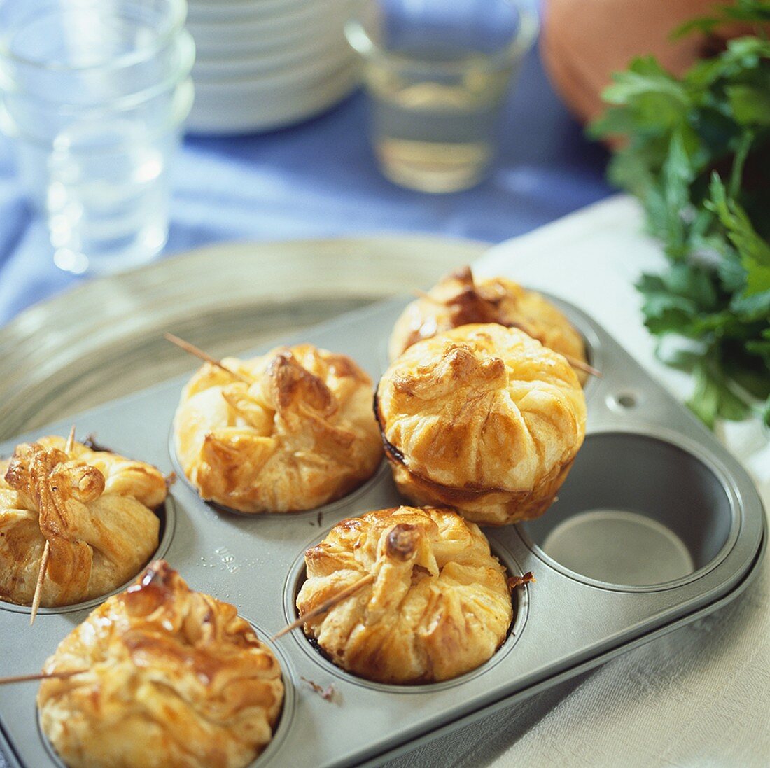 Puff pastry purses filled with turkey & ham in a muffin tin