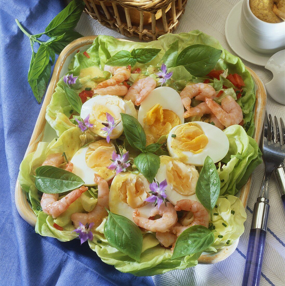 Hard-boiled eggs in mustard sauce with shrimps on lettuce