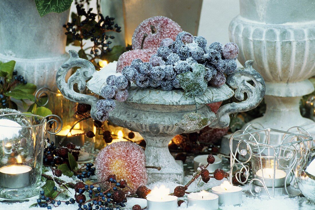 Winter decoration: sugared fruit in cast stone vase