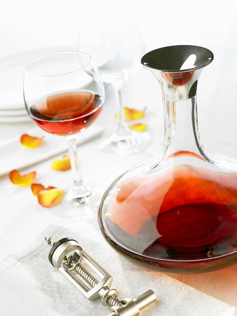 Red wine in glass and carafe, corkscrew