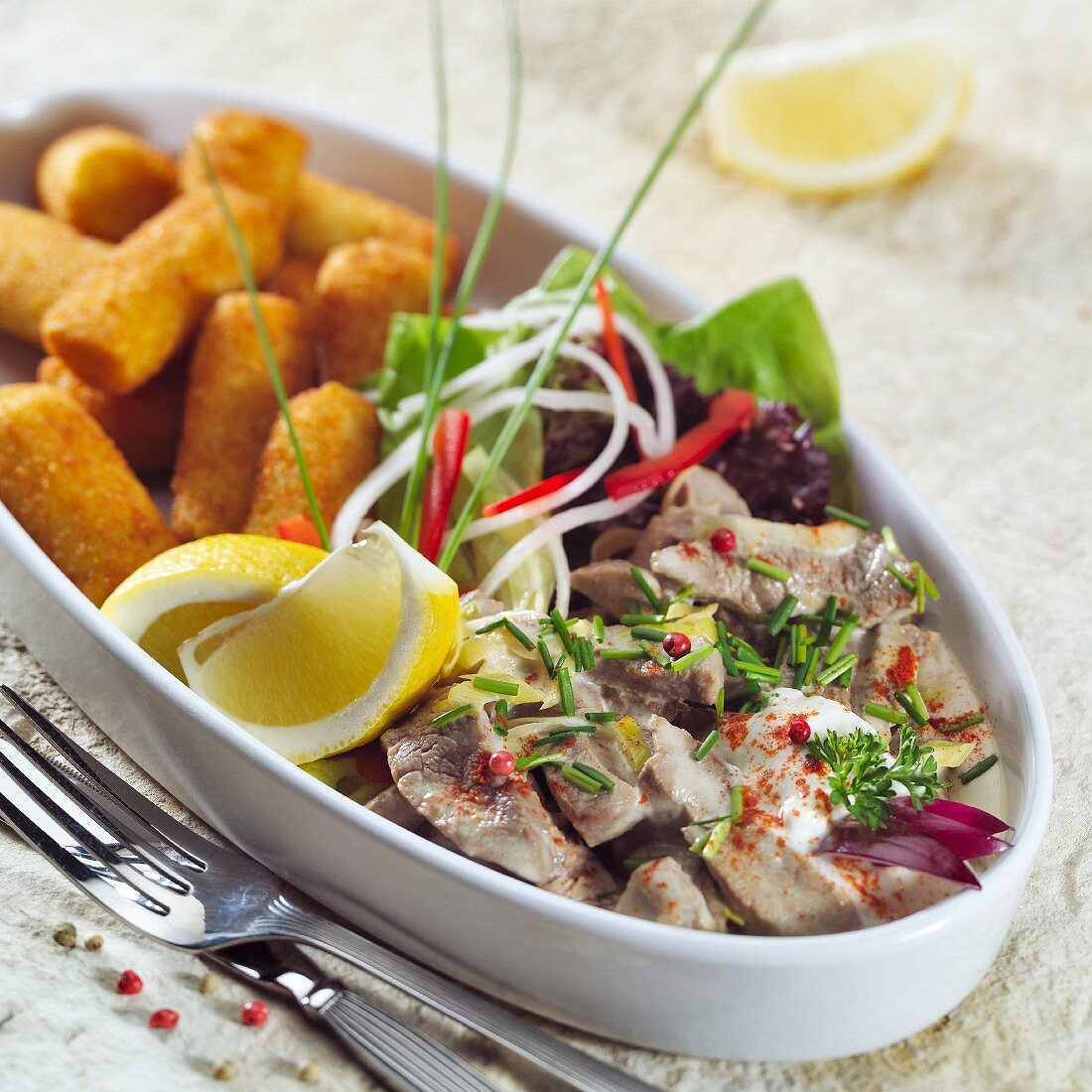 Strips of meat with mustard sauce and potato croquettes