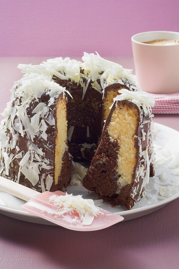 Marble cake with chocolate icing and white chocolate shavings