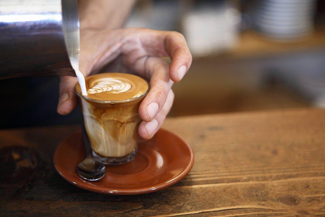 Barista making caffè latte