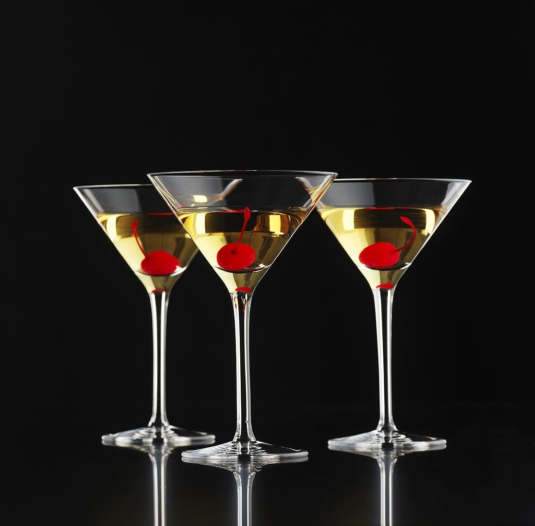 Three Martinis with cocktail cherries