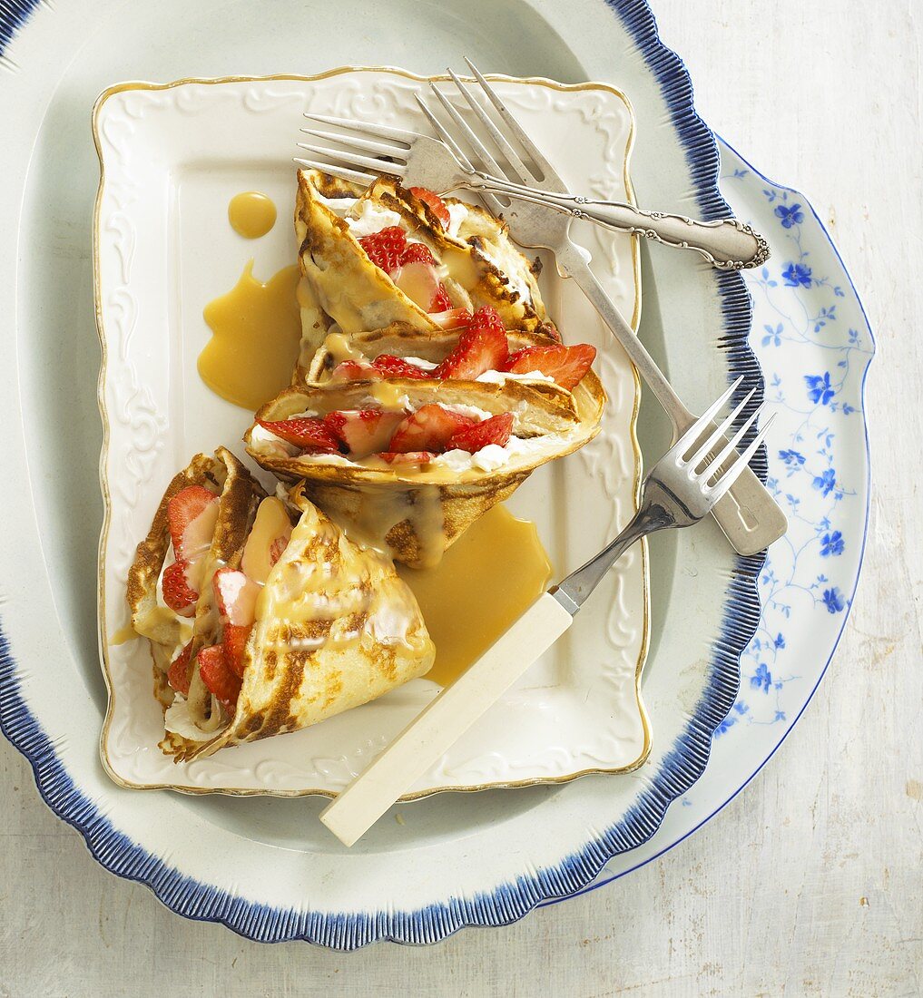 Pancakes with strawberries and caramel sauce