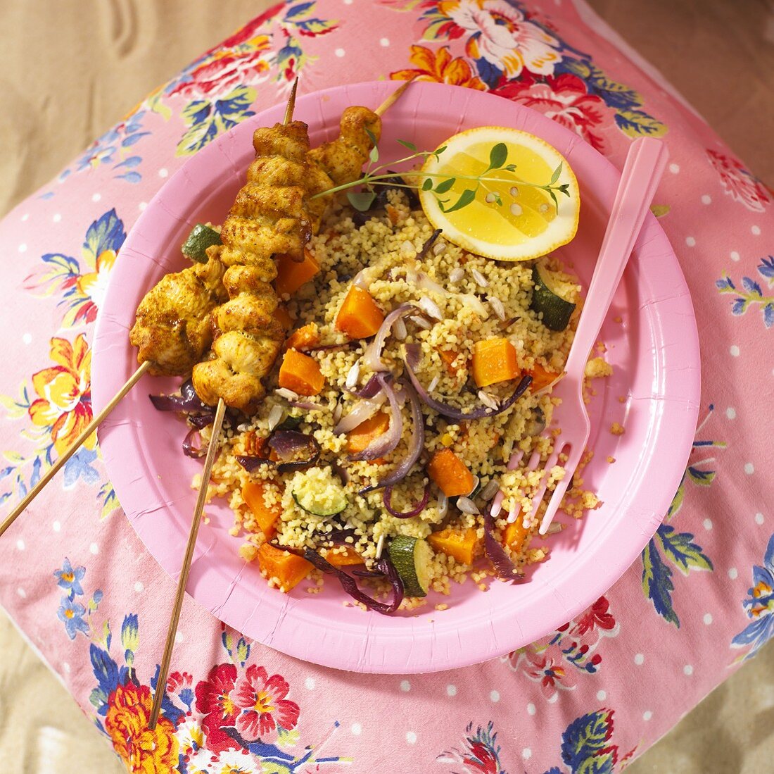 Chicken skewers and couscous with butternut squash (overhead view)