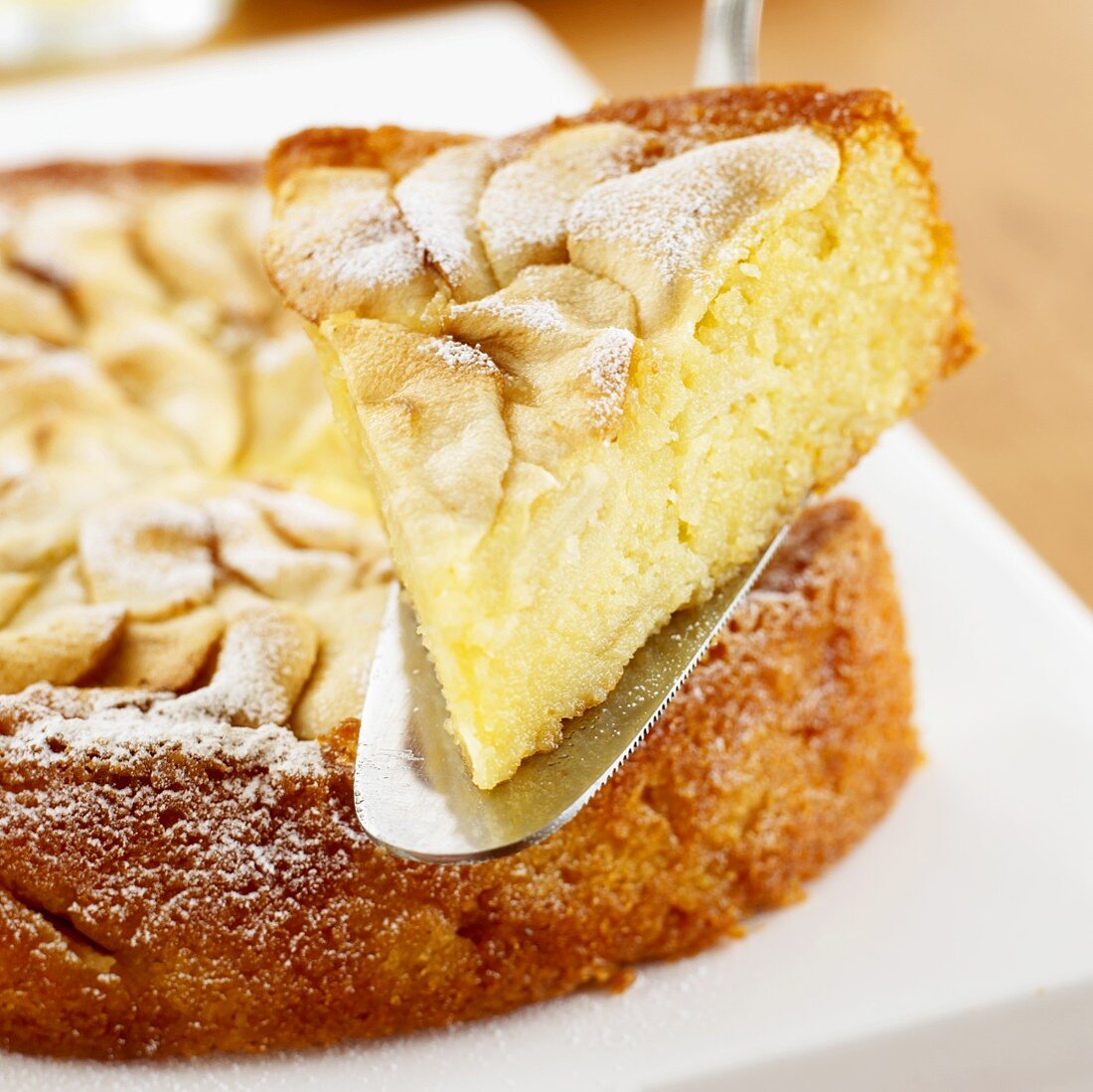 Piece of apple and almond cake on cake server