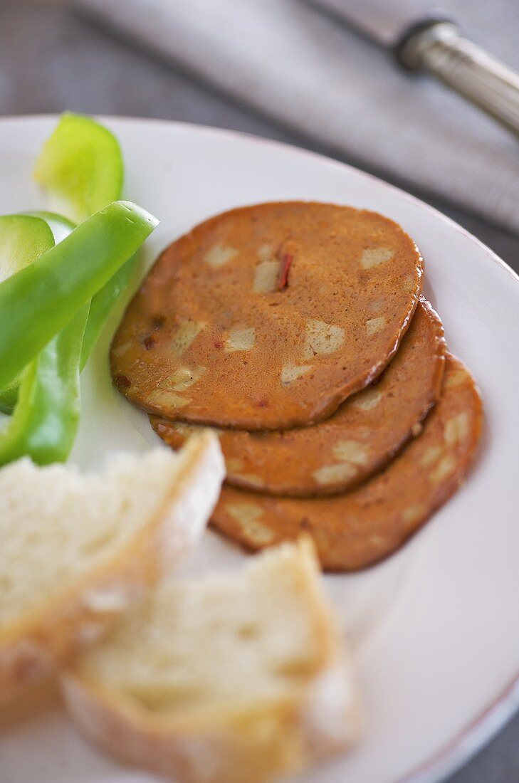 Baguette, green pepper and slices of sausage