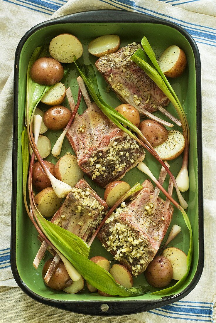 Marinated lamb chops with vegetables in a roasting dish