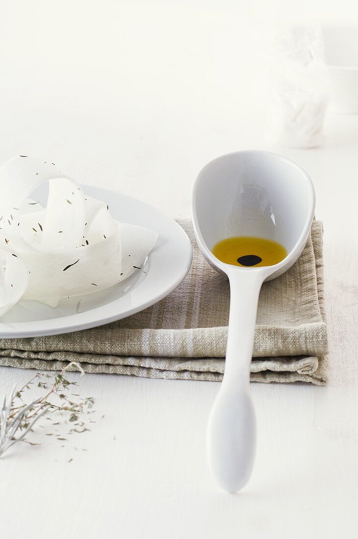 White radish salad and ladle with olive oil