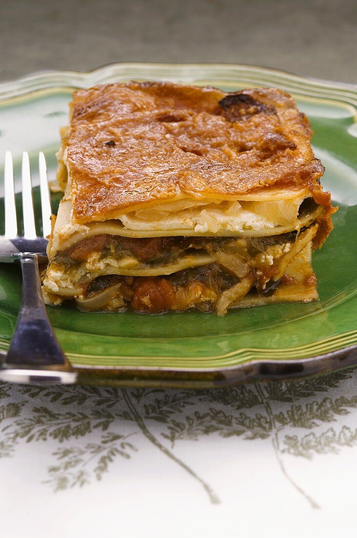 Vegetable lasagne on plate with fork