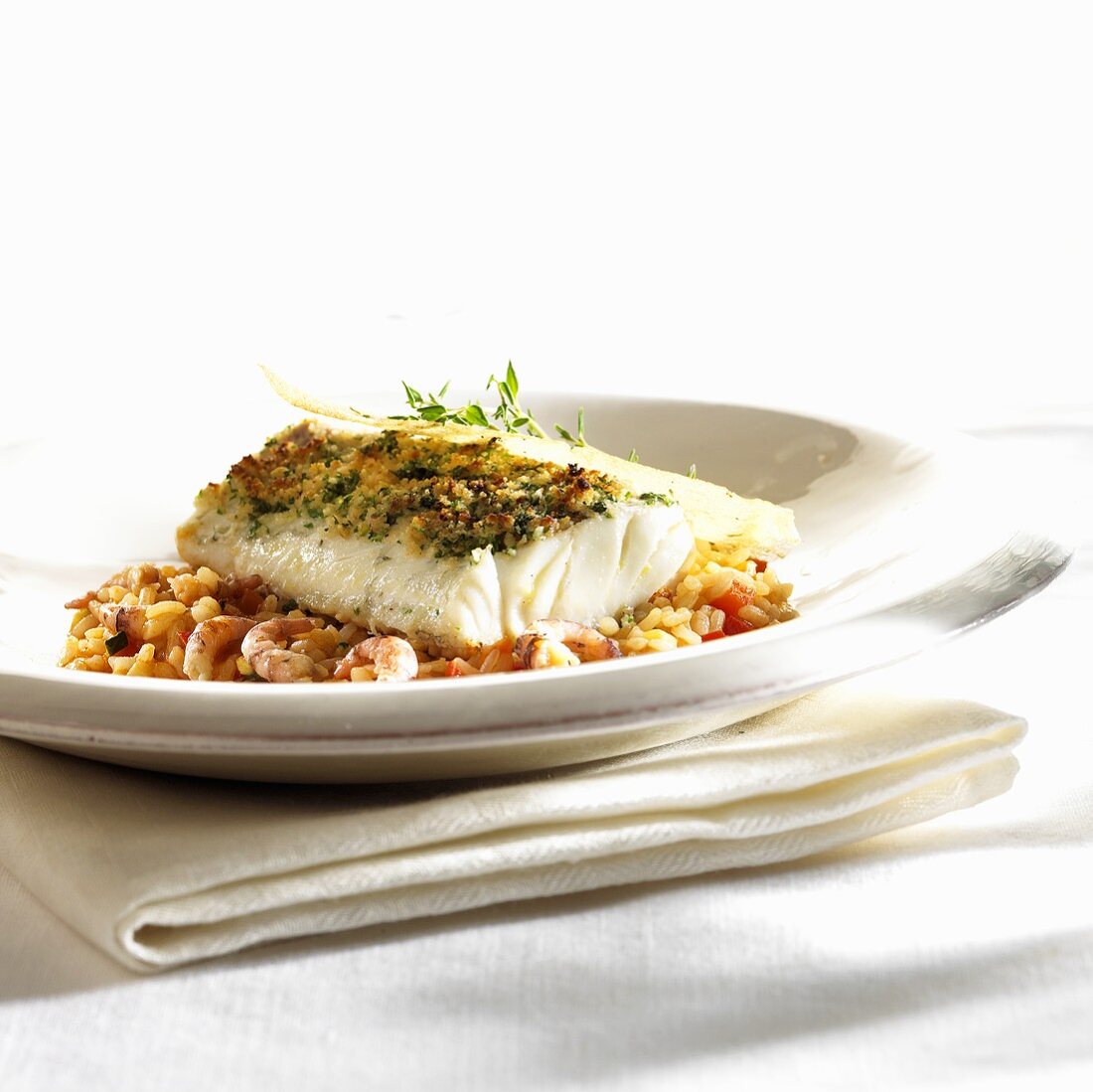 Cod with herb crust on tomato risotto