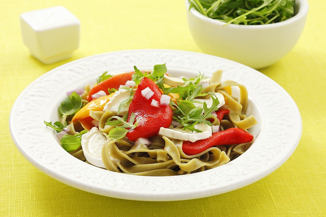 Green tagliatelle with grilled peppers, rocket and goat's cheese