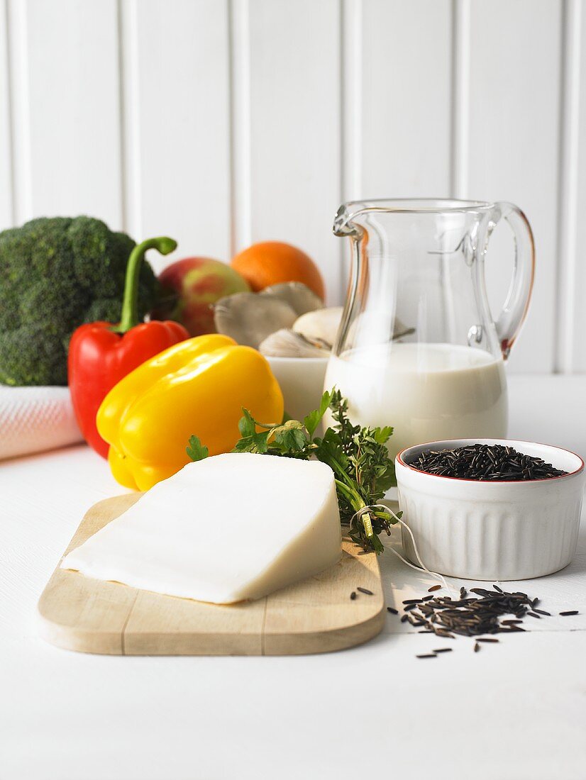 Still life with vegetables, fruit, milk, wild rice, cheese, herbs