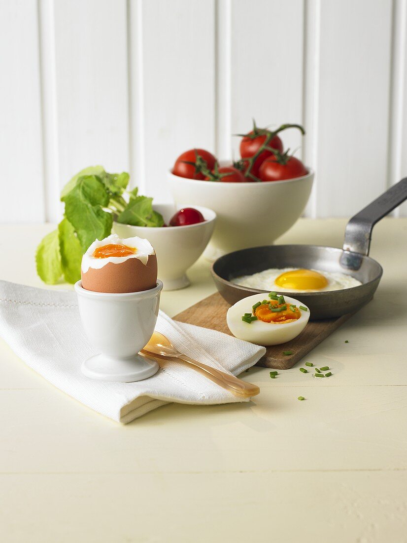 Soft-boiled egg, hard-boiled egg, fried egg, tomatoes and radishes