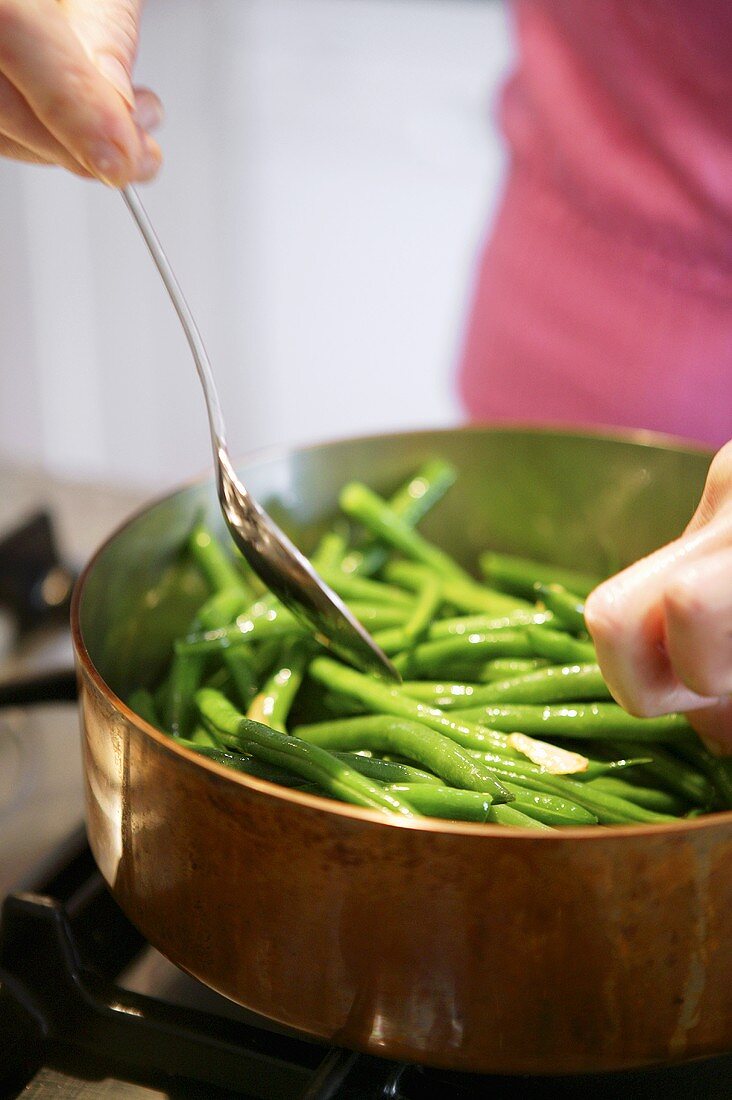 Sweating green beans in copper pan