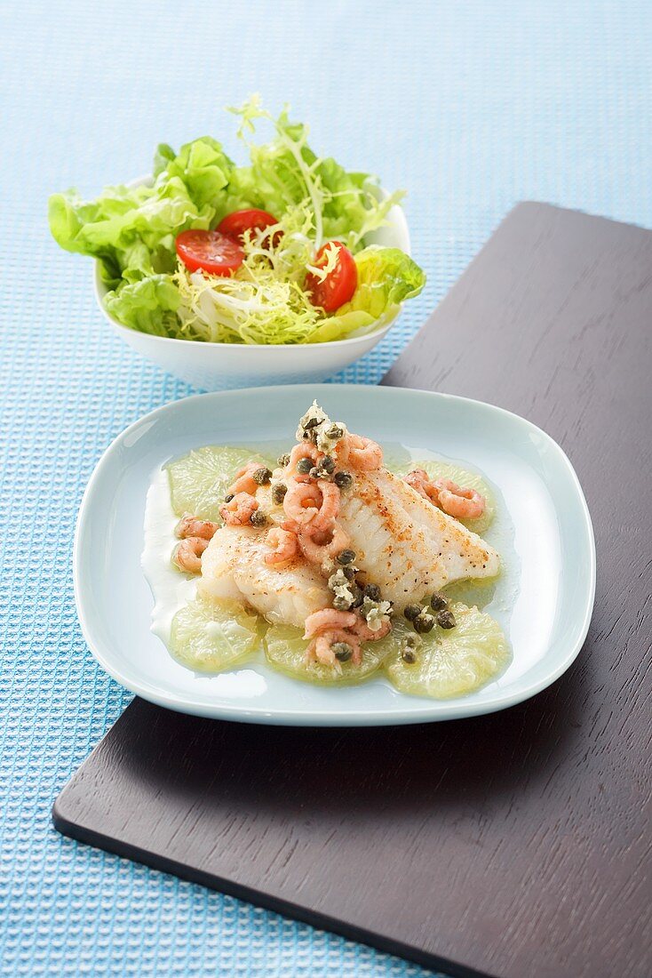 Fish fillet with fried capers, lime and shrimps