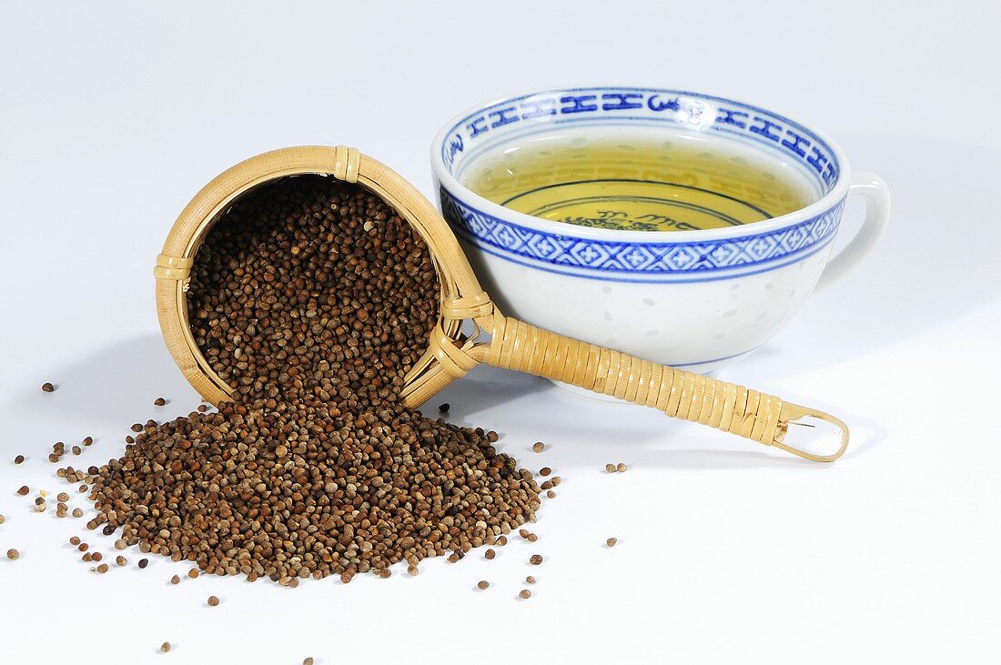 Perilla seeds with tea strainer and cup of tea