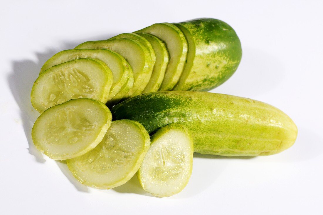 Two Thai cucumbers, one whole and one sliced