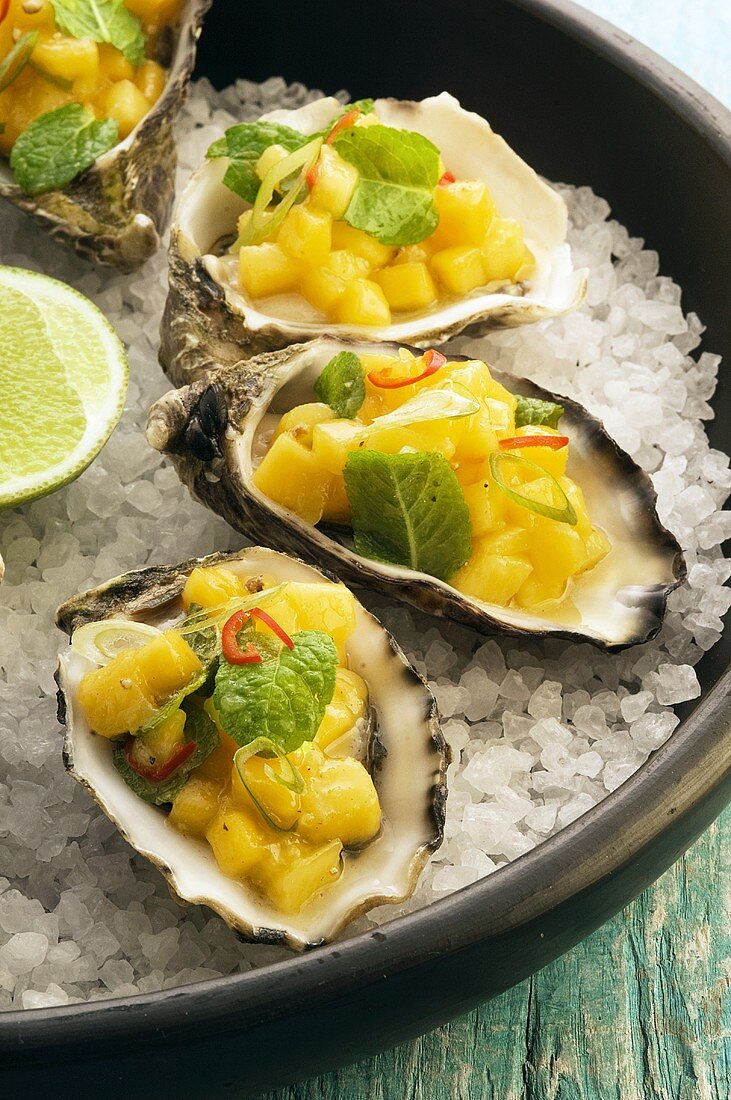 Oysters with mango salsa on ice