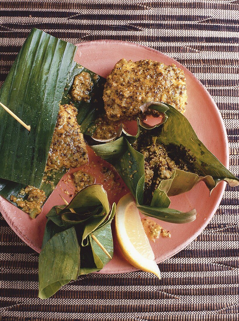 Banana flower in parcel, fish with mustard in banana leaf (India)