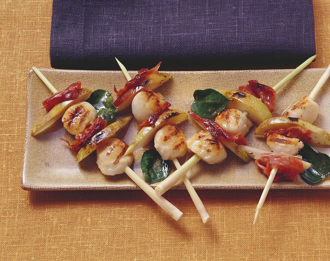 Barbecued scallops skewered on lemon grass