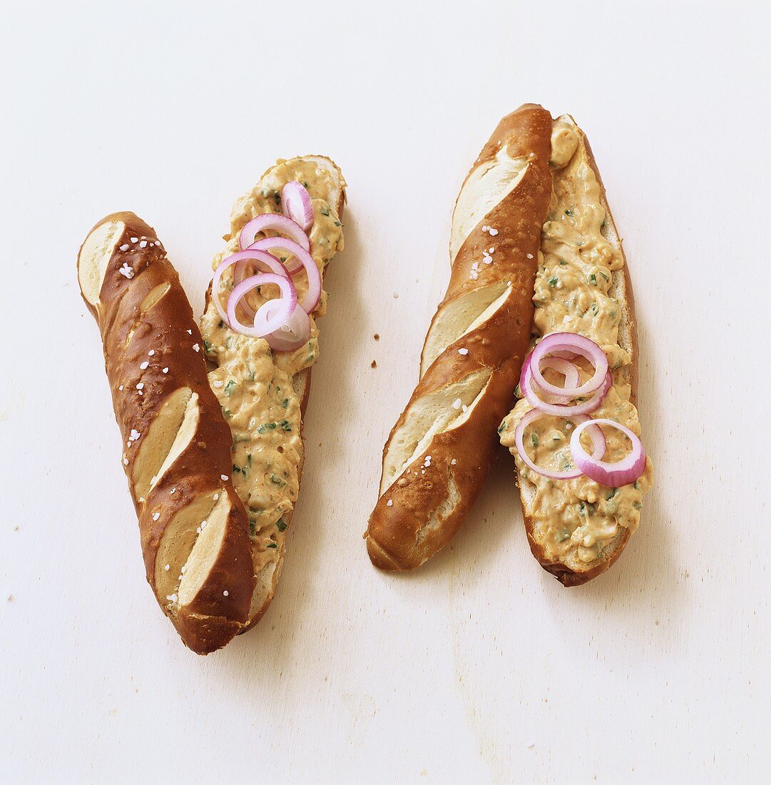 Two pretzel sticks with goat’s cheese spread