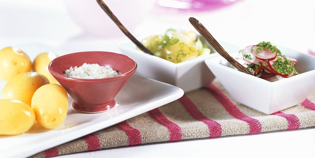 Boiled potatoes with two salads