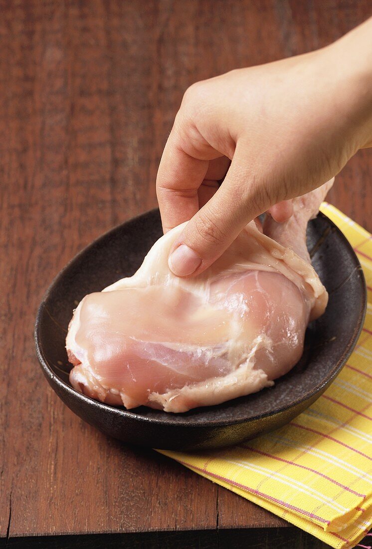 Skinning a piece of chicken