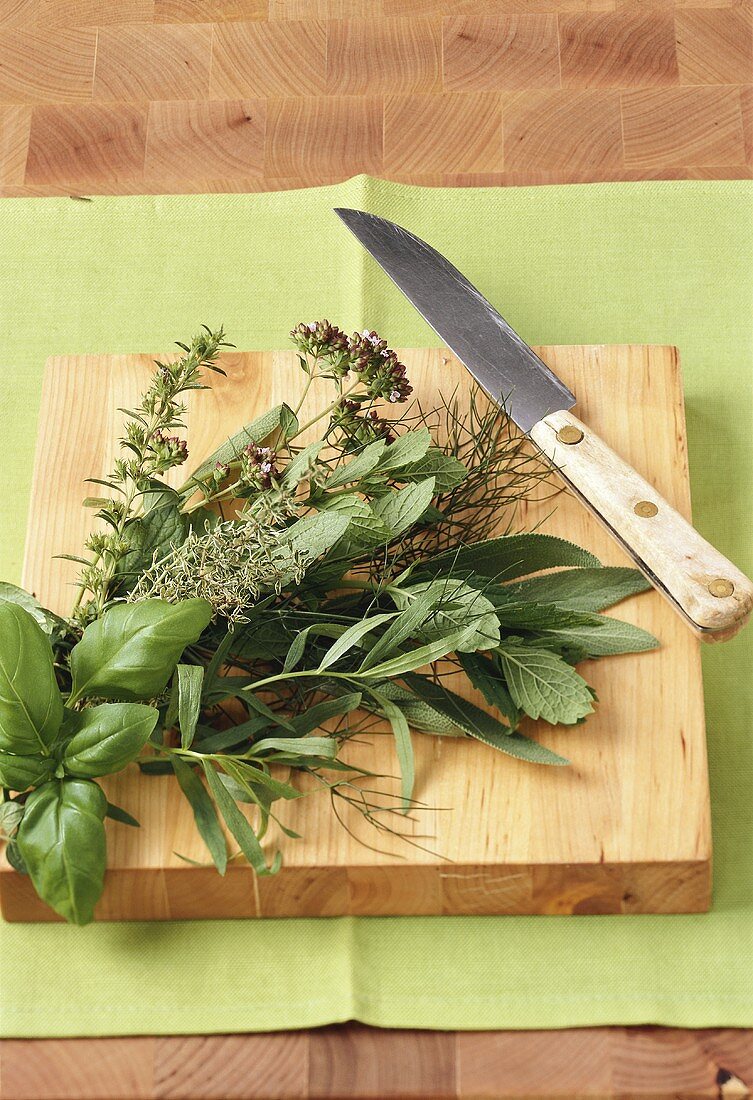 Bunch of herbs on a wooden board