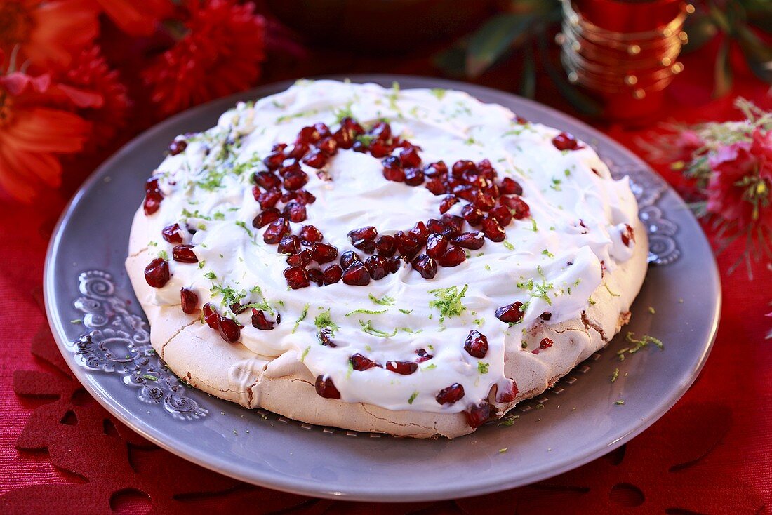 Pavlova with lime cream and heart in pomegranate seeds