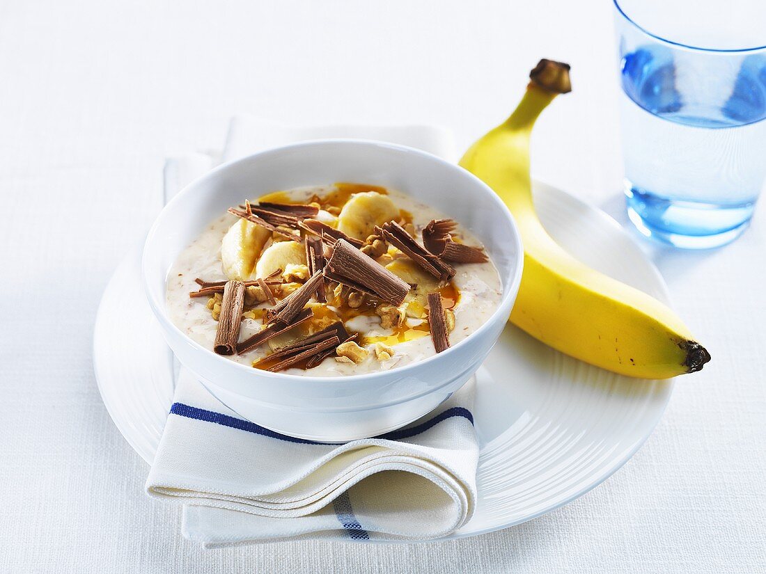 Yoghurt with banana, nuts and chocolate curls