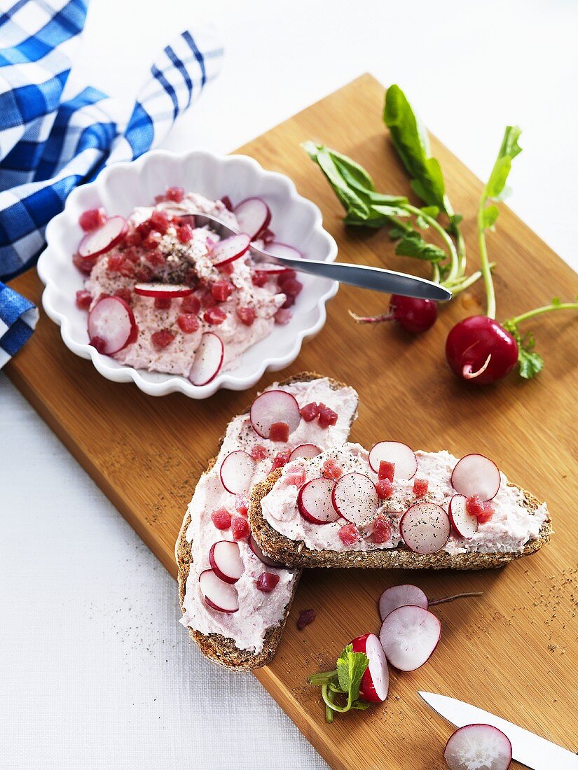 Soft cheese spread with raw ham and radishes