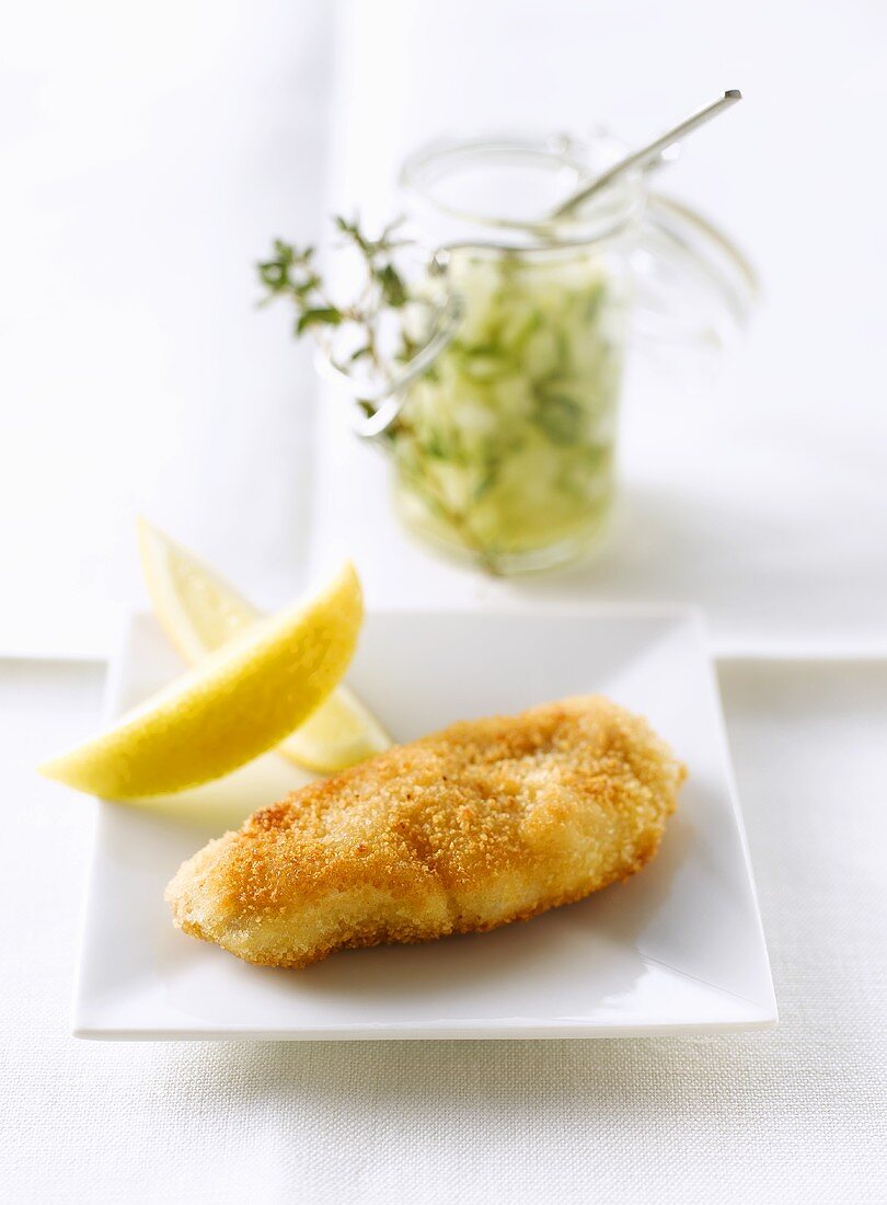 Small breaded escalope with cucumber relish in preserving jar