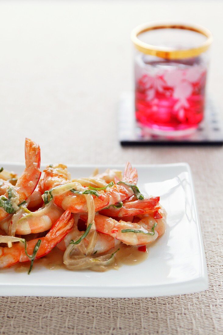 Satay prawns with onions and herbs