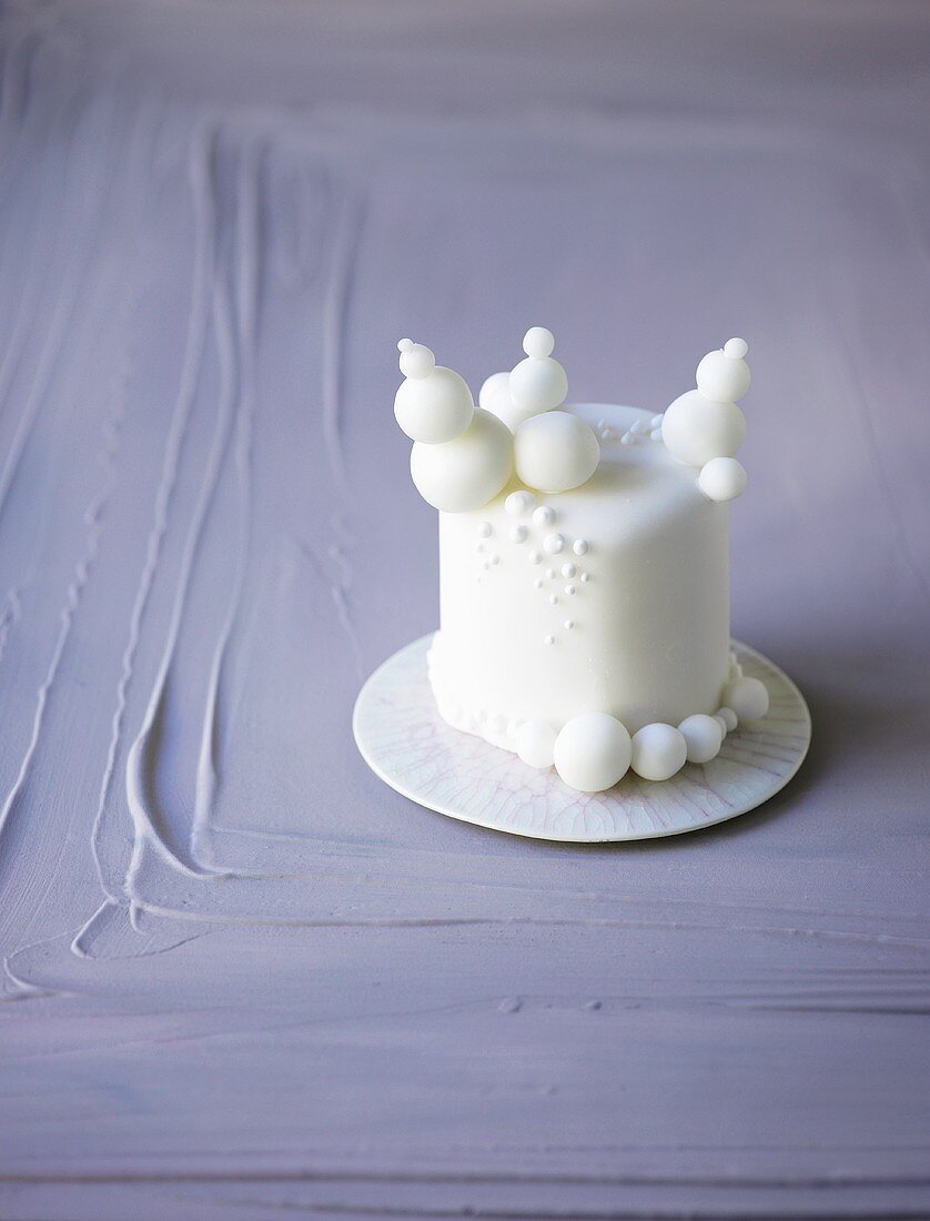 Small white cake with fondant decorations