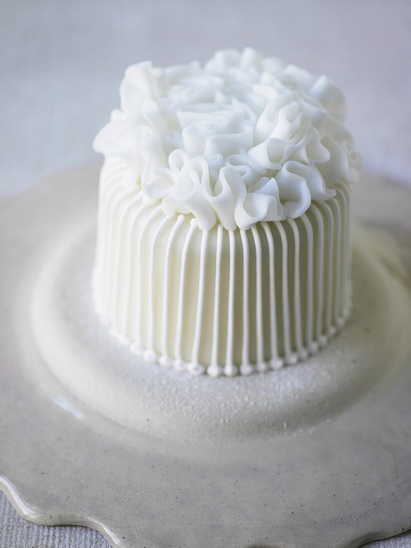 Small white cake with ruffle decoration