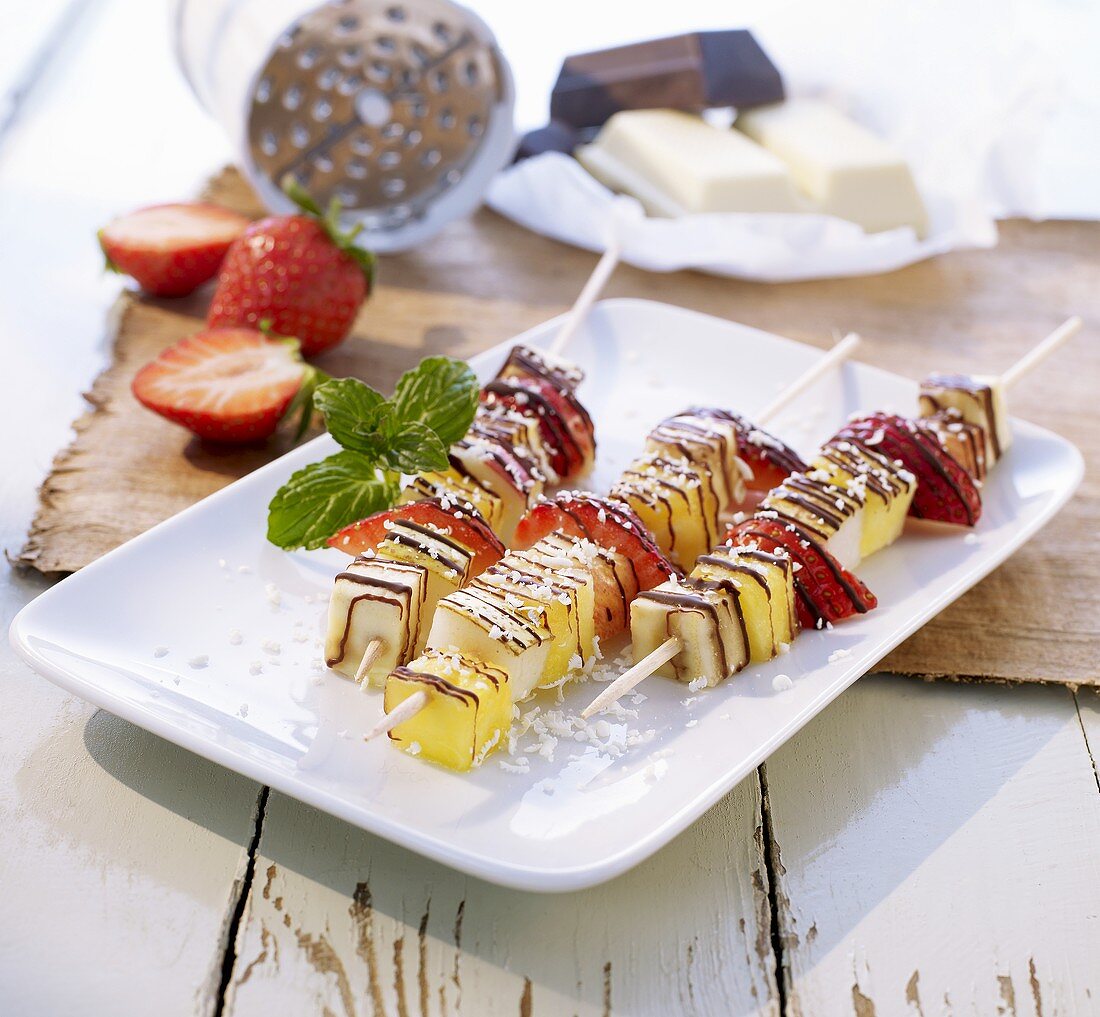 Fruit skewers with chocolate drizzle and grated coconut